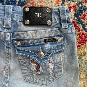 Miss Me Signature Rhinestone Embroidered Blow Out Flap Pocket Skinny Jeans